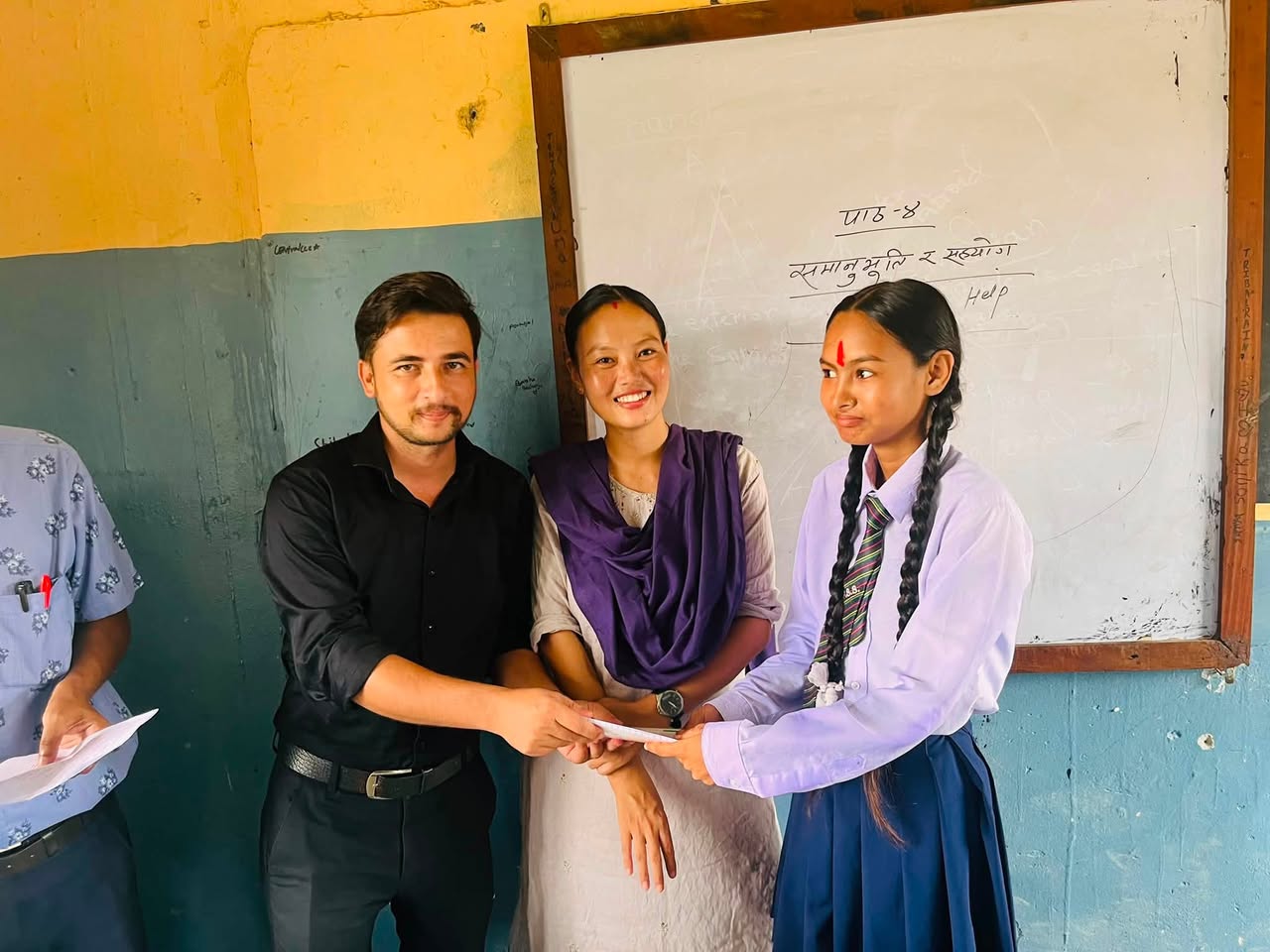 Teachers awarding merit certificate to secondary school student in classroom